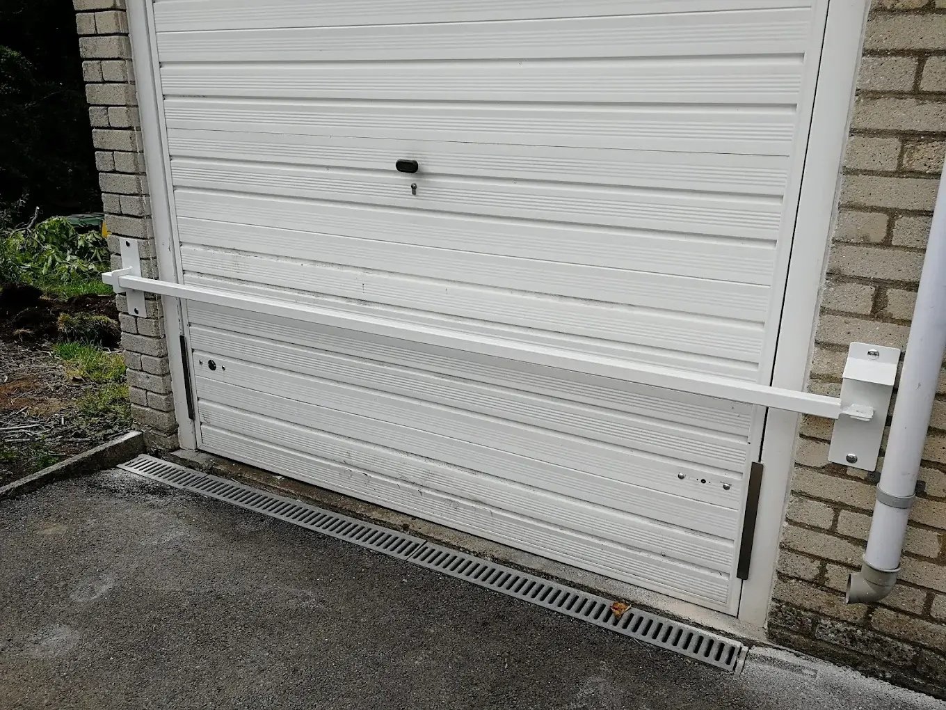 Heavy-duty garage door security lock bar installed for added home protection